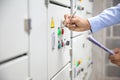 Technician checking air handling unit AHU starter button control panel of heating and air