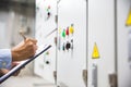 Technician checking air handling unit AHU starter button control panel of heating and air Royalty Free Stock Photo