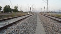 Electricity Indian railway track view with Cement block sleepers. Long rail line view with pebbles