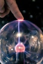 Electricity lighting ray going to a finger hand on a powerful spark sphere