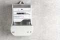 Electricity meter on concrete wall background with copy space for text Royalty Free Stock Photo
