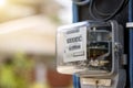 Electricity meters for home electrical appliances, including blurred natural green backgrounds.