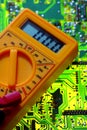 Electricity multimeter on circuit board Royalty Free Stock Photo