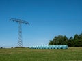 Electricity pole on a field with hay bales Royalty Free Stock Photo