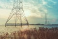 Electricity poles in the lake Buiten IJ with the Amsterdam district IJburg in the background.