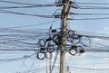 Electricity post with many wires and cables in the countryside of Thailand. Royalty Free Stock Photo