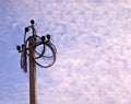 Electricity power pole with many disconnected wires on blue cloudy sky background. Royalty Free Stock Photo