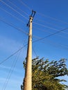 Electricity Pylon Against Blue Sky: Low Angle View of Transmission Tower and Power Lines Royalty Free Stock Photo