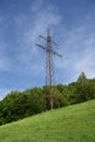 Electricity pylon in green meadow in spring Royalty Free Stock Photo