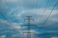 Electricity pylon with overhead powerline cables against cloudy sky Royalty Free Stock Photo