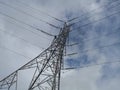 Electricity pylon standing tall with a cloudy blue sky Royalty Free Stock Photo