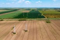 Electricity pylon transmission towers and power lines on cultivated field, drone pov