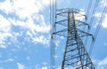 Electricity pylons with blue sky and white clouds. High voltage grid tower with wire cable at distribution station. High voltage Royalty Free Stock Photo