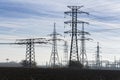 Electricity pylons with distribution power station blue cloudy sky background Royalty Free Stock Photo