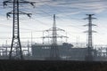 Electricity pylons with distribution power station blue cloudy sky background Royalty Free Stock Photo