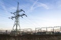 Electricity pylons with distribution power station blue cloudy sky background Royalty Free Stock Photo