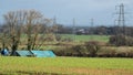 Electricity pylons dominating farmland in Devon UK