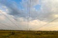 Electricity pylons and high voltage power line at sunset. Royalty Free Stock Photo