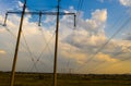 Electricity pylons and high voltage power line at sunset. Royalty Free Stock Photo