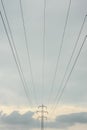 Electricity pylons and power lines. High voltage towers and cloudy sky. Royalty Free Stock Photo