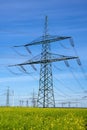 An electricity pylons, power lines and some wind turbines Royalty Free Stock Photo