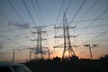 Electricity pylons and power lines, at sunset Royalty Free Stock Photo