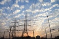 Electricity pylons and power lines, at sunset Royalty Free Stock Photo