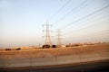 Electricity pylons and power lines, at sunset Royalty Free Stock Photo