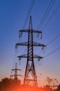 Electricity pylons and power lines at sunset. High voltage stantion. Royalty Free Stock Photo