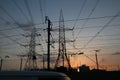 Electricity pylons and power lines, at sunset Royalty Free Stock Photo