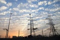 Electricity pylons and power lines, at sunset Royalty Free Stock Photo