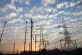 Electricity pylons and power lines, at sunset Royalty Free Stock Photo