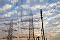 Electricity pylons and power lines, at sunset Royalty Free Stock Photo