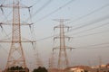 Electricity pylons and power lines, at sunset Royalty Free Stock Photo