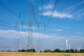 Electricity pylons, power lines and wind turbines Royalty Free Stock Photo