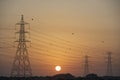 Electricity Pylons Silhouetted At Sunset Royalty Free Stock Photo