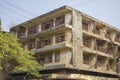 Electricity street wires on the background of an old yellow shabby asian low-rise house Royalty Free Stock Photo