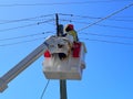 Electricity technician fixing high voltage electric power distribution supply line