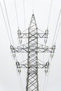 Electricity transmission power lines, Electricity pylon against the background of a light, almost white sky Royalty Free Stock Photo