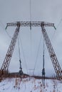 Electricity transmission power lines on winter background High voltage tower Royalty Free Stock Photo