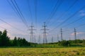 Electricity transmission pylon tower, high voltage power line among the fields.  Distribution station. Supplying cities with Royalty Free Stock Photo