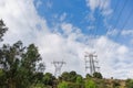 Electricity transmission towers against blue sky background Royalty Free Stock Photo