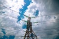 Electricity transmission towers or pylons with cables and cloudy sky. Royalty Free Stock Photo