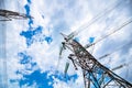 Electricity transmission towers or pylons with cables and cloudy sky. Royalty Free Stock Photo