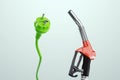 Electricity versus combustible fuel. Gas station nozzle and electrical plug. Technology, car costs, electric car vs gasoline car. Royalty Free Stock Photo