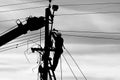 Electricity worker fixing power line on stormy winter day Royalty Free Stock Photo