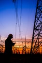 Electricity workers and pylon silhouette Royalty Free Stock Photo