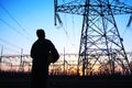 electricity workers and pylon silhouette Royalty Free Stock Photo