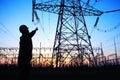 electricity workers and pylon silhouette Royalty Free Stock Photo