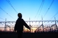 electricity workers and pylon silhouette